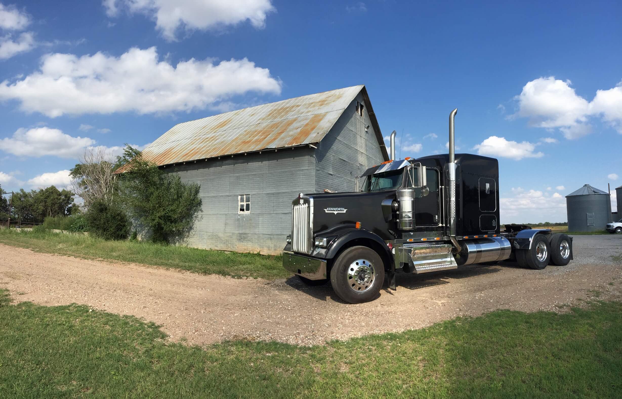 Kenworth by a barn